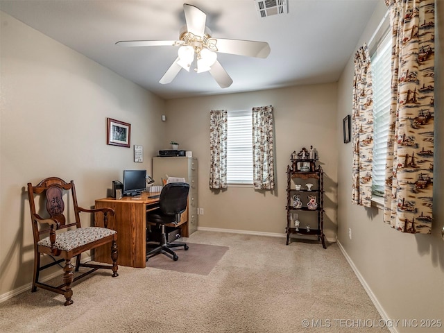 home office with a ceiling fan, carpet, visible vents, and baseboards