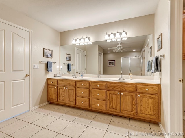 full bathroom with double vanity, a stall shower, a sink, ceiling fan, and tile patterned flooring