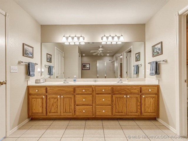 bathroom featuring double vanity, a ceiling fan, tile patterned flooring, a shower stall, and a sink