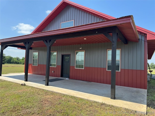 view of front of home with board and batten siding and a front lawn