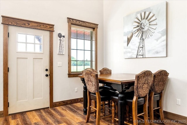 dining area featuring baseboards and wood finished floors