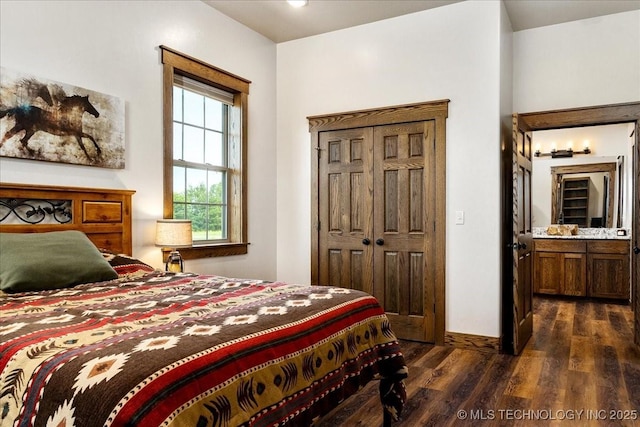 bedroom featuring dark wood-style floors and baseboards