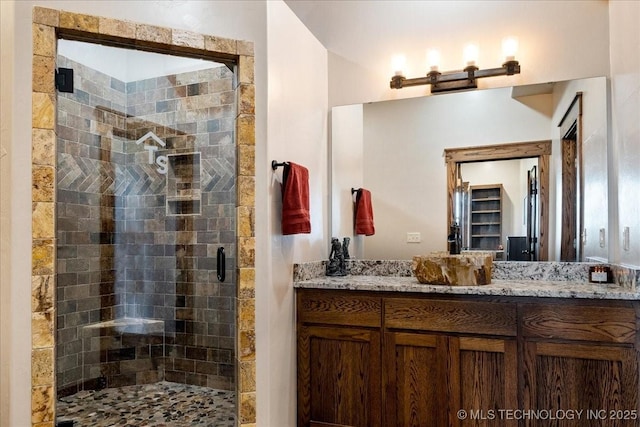 bathroom featuring a stall shower and vanity