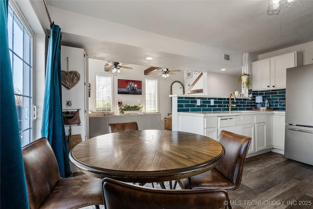 dining area with dark wood-style floors, visible vents, and recessed lighting