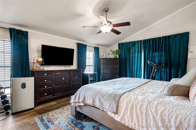 bedroom featuring vaulted ceiling, wood finished floors, and a ceiling fan