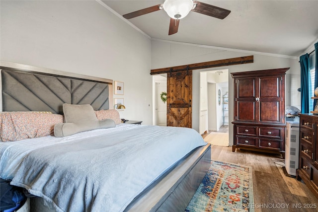 bedroom with crown molding, a barn door, a ceiling fan, vaulted ceiling, and light wood-type flooring