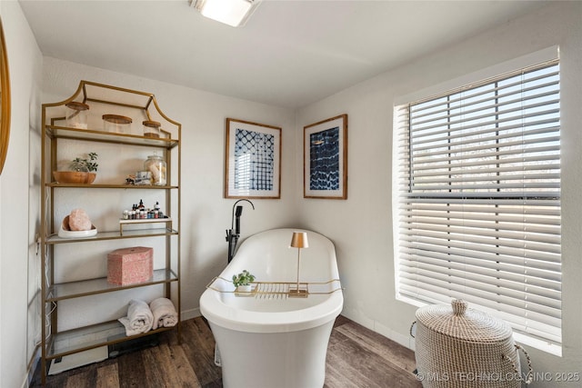 interior space with wood finished floors and baseboards