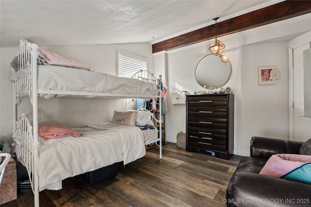 bedroom featuring lofted ceiling with beams, a textured ceiling, and wood finished floors