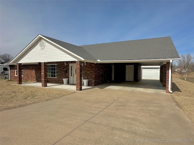 ranch-style home with a shingled roof, concrete driveway, and brick siding