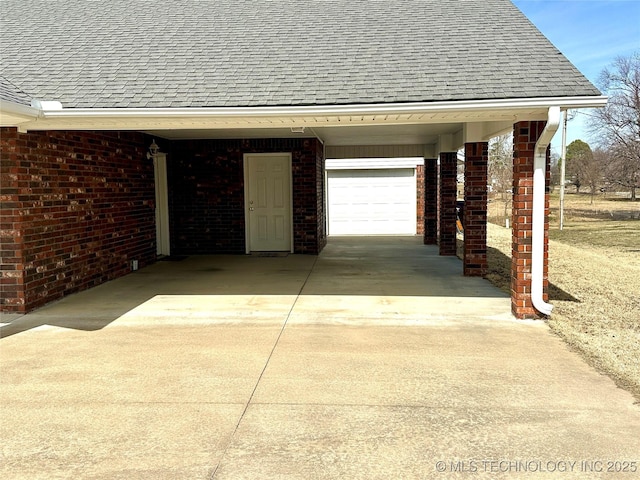 garage featuring concrete driveway