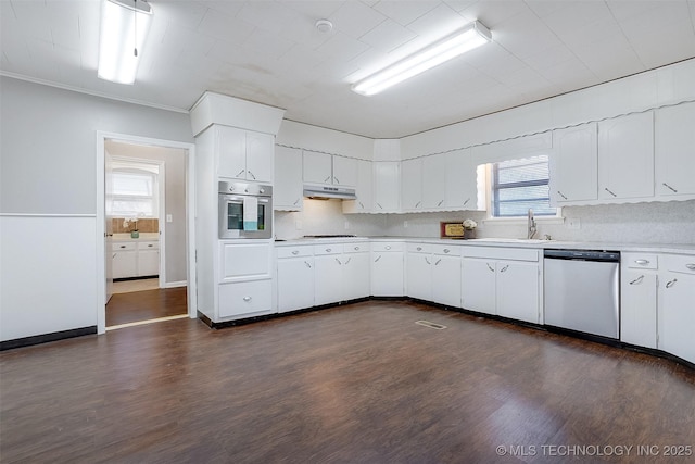 kitchen with white cabinets, dark wood finished floors, stainless steel appliances, and light countertops