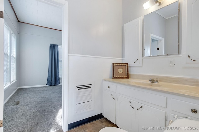 bathroom with visible vents, vanity, and crown molding