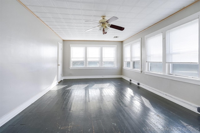 unfurnished sunroom with a ceiling fan and visible vents