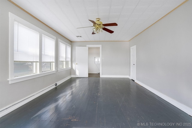 unfurnished room featuring crown molding, visible vents, ceiling fan, baseboards, and hardwood / wood-style flooring