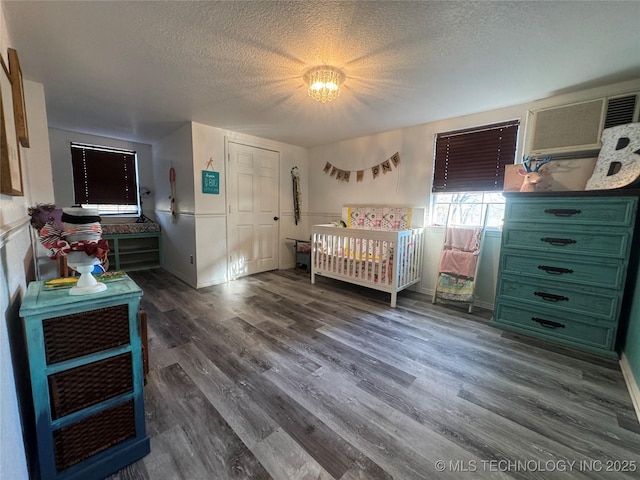 bedroom with dark wood-style flooring and a textured ceiling