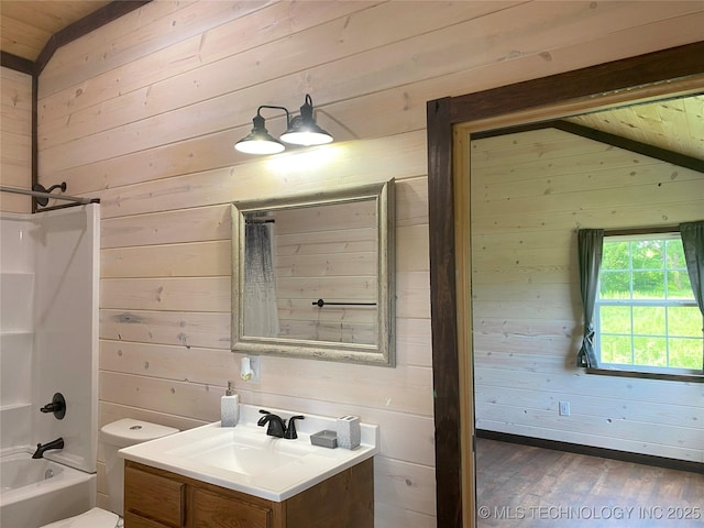 bathroom featuring shower / tub combo with curtain, lofted ceiling, wooden walls, vanity, and wood finished floors