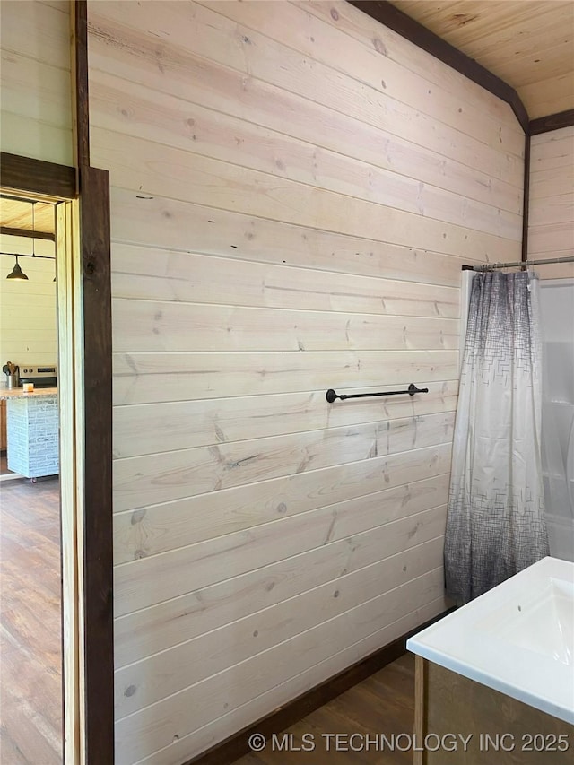 bathroom featuring wood walls, wood ceiling, and wood finished floors