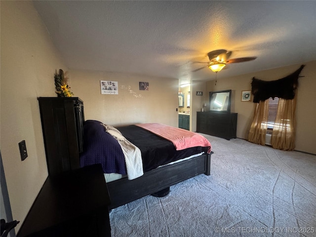 carpeted bedroom featuring ceiling fan, connected bathroom, and a textured ceiling