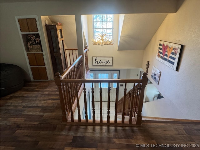 stairway featuring baseboards and wood finished floors