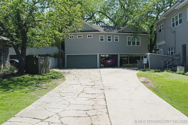 view of front facade with a carport, concrete driveway, and a front lawn