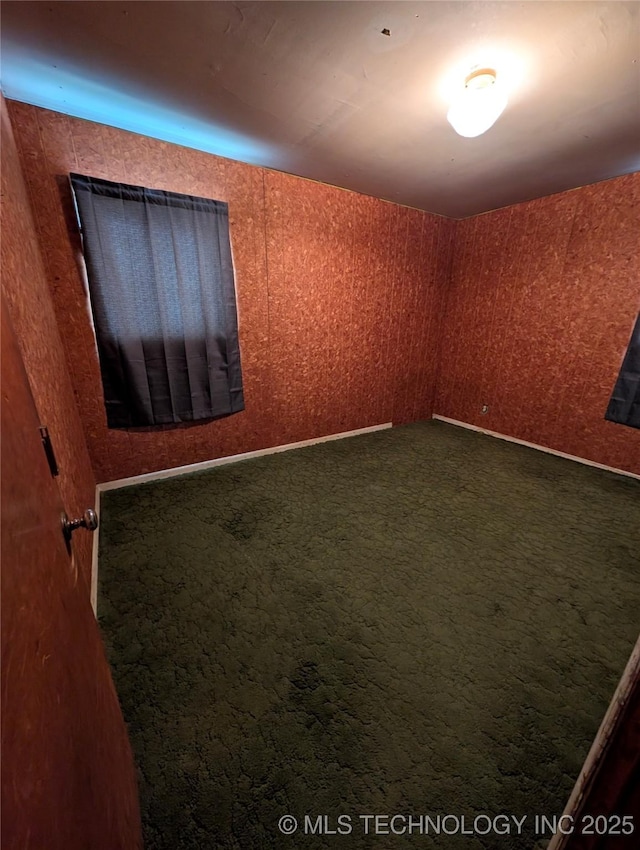 empty room with dark carpet