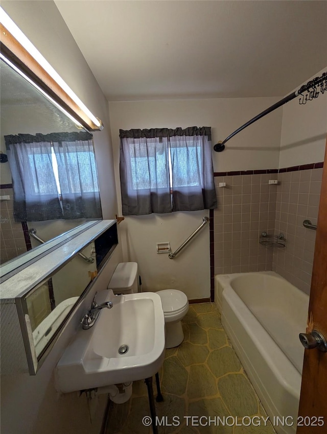 full bath with tub / shower combination, a sink, and toilet