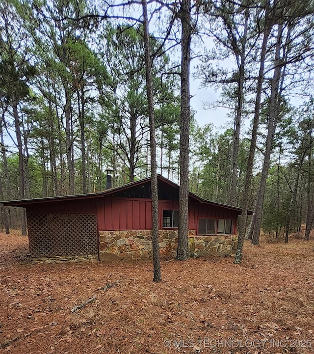 view of home's exterior featuring stone siding and board and batten siding