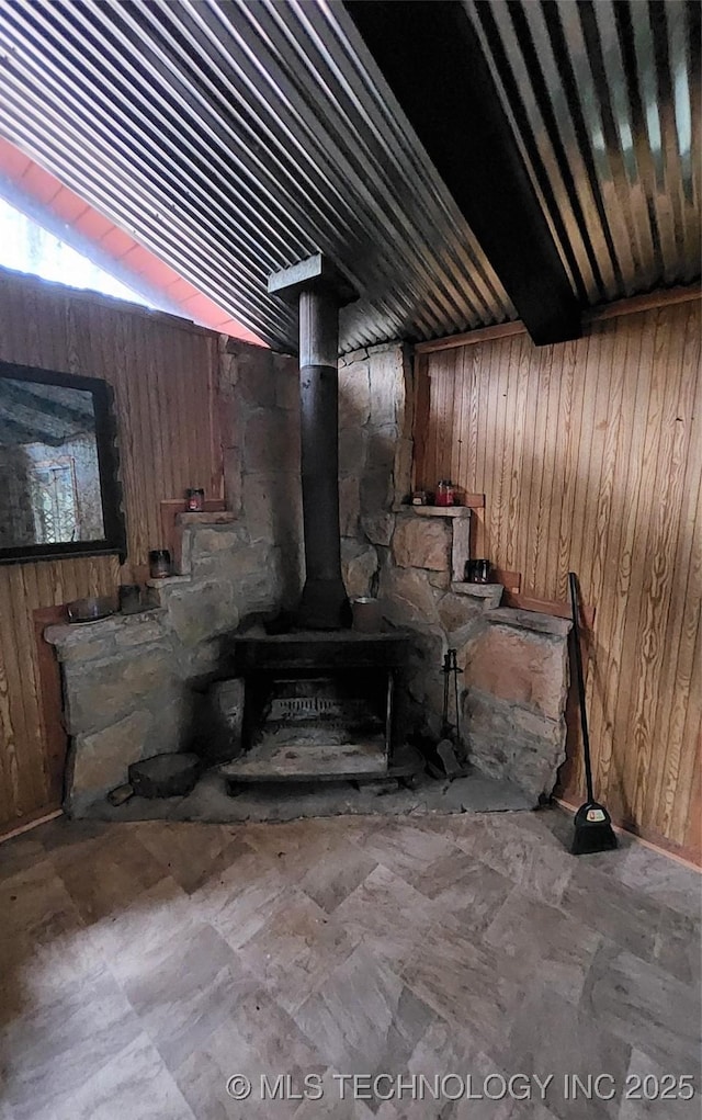 interior details with wood walls and a wood stove