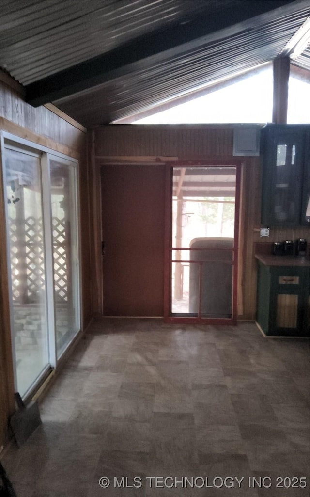 interior space featuring carpet flooring and beamed ceiling