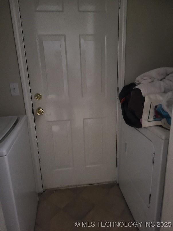 clothes washing area featuring laundry area and washer / dryer