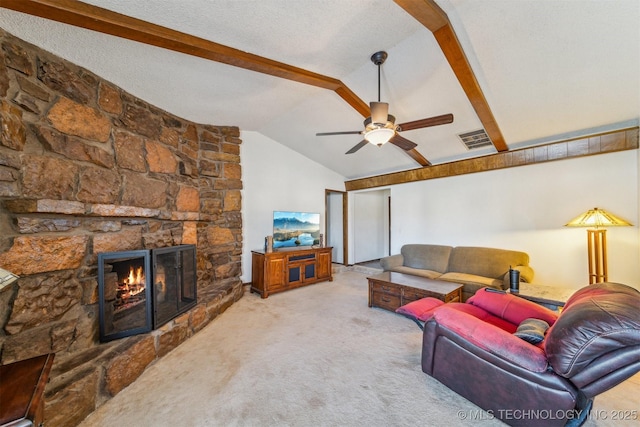 carpeted living room featuring vaulted ceiling with beams, ceiling fan, a textured ceiling, a fireplace, and visible vents