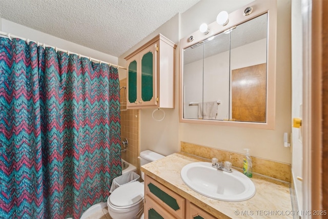 bathroom with toilet, shower / bath combo, a textured ceiling, and vanity