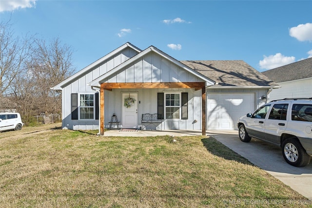 view of front facade featuring a porch, a garage, concrete driveway, board and batten siding, and a front yard