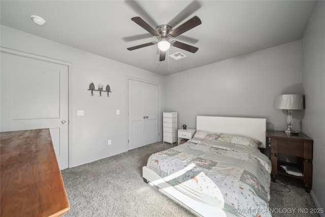 carpeted bedroom with a ceiling fan, a closet, and visible vents