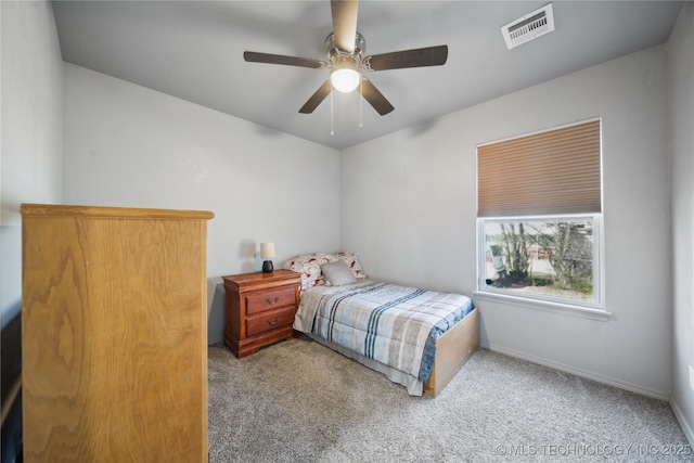 carpeted bedroom with a ceiling fan, visible vents, and baseboards