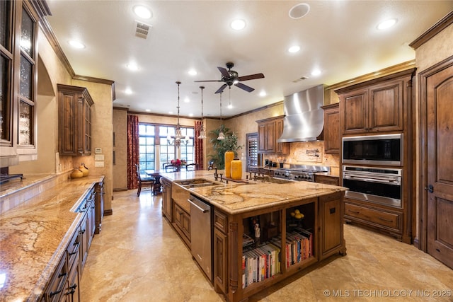 kitchen featuring appliances with stainless steel finishes, a large island, ornamental molding, and wall chimney range hood