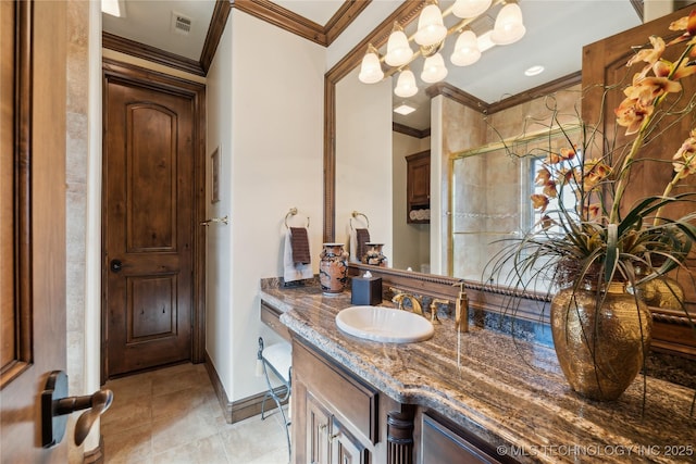 bathroom featuring baseboards, tile patterned floors, crown molding, vanity, and a shower stall