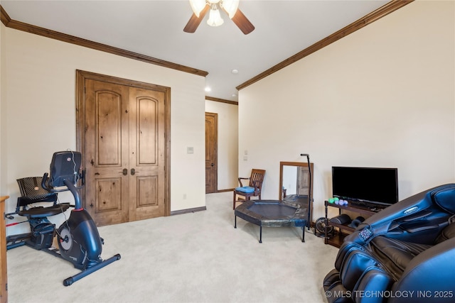 workout room with a ceiling fan, light carpet, crown molding, and baseboards