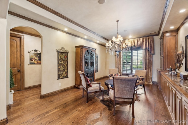 dining space with baseboards, arched walkways, wood finished floors, a notable chandelier, and recessed lighting