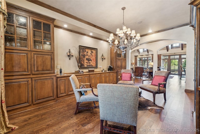 dining room featuring arched walkways, dark wood finished floors, and recessed lighting