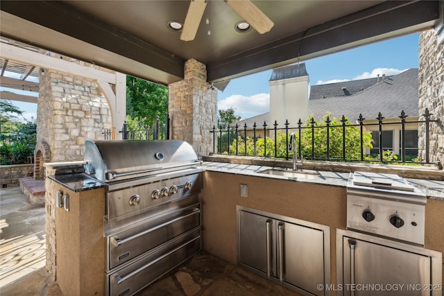 view of patio with area for grilling, a sink, and an outdoor kitchen