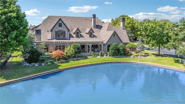 view of pool featuring a yard and a pergola