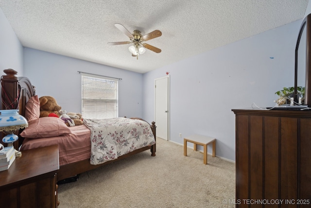 bedroom featuring light colored carpet, a ceiling fan, and a textured ceiling