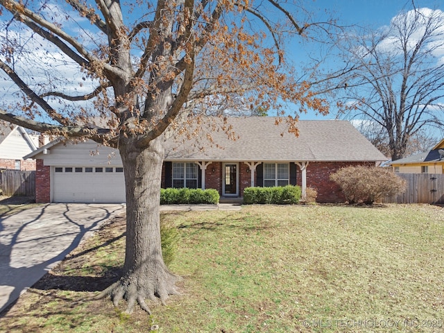 ranch-style house with brick siding, a front lawn, and fence