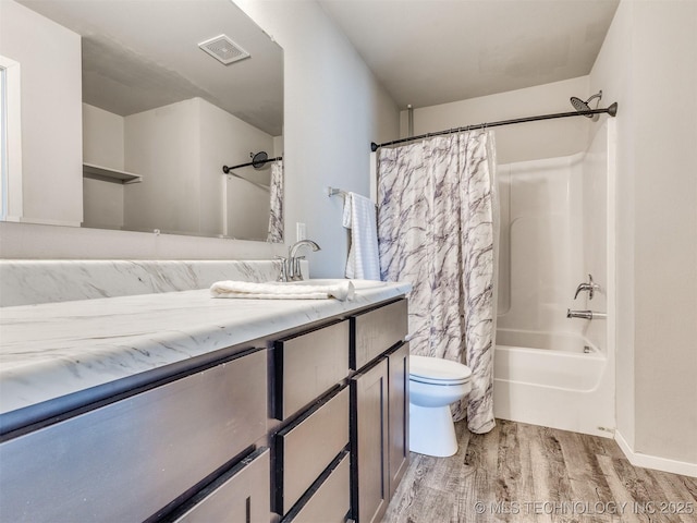 bathroom featuring visible vents, toilet, shower / bath combo, vanity, and wood finished floors