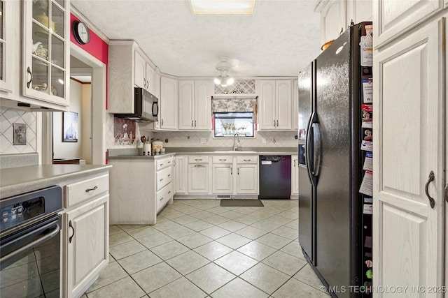 kitchen with decorative backsplash, glass insert cabinets, light tile patterned flooring, ceiling fan, and black appliances