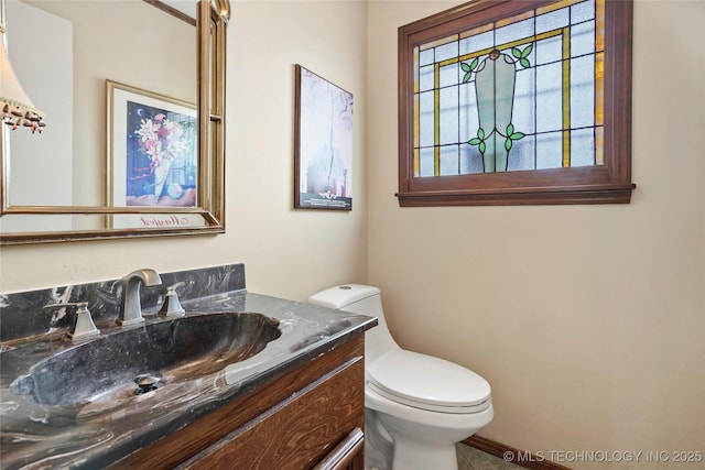 bathroom featuring toilet and vanity