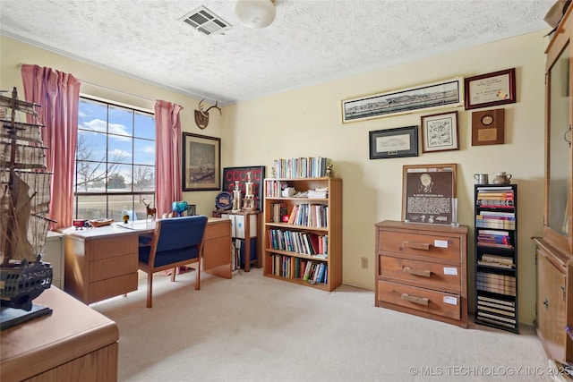 carpeted home office featuring visible vents and a textured ceiling