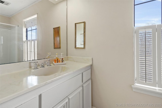 full bath with walk in shower, vanity, and visible vents