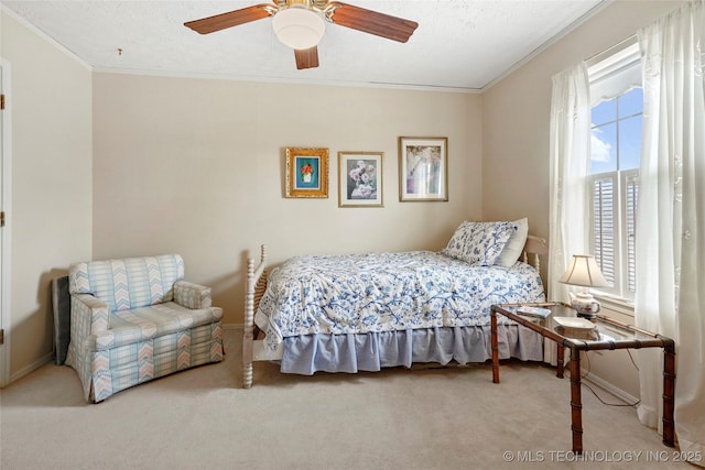 bedroom with baseboards, a ceiling fan, crown molding, and carpet flooring